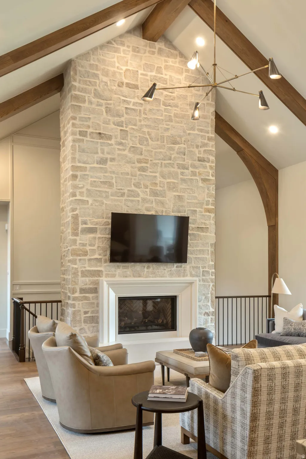 Vaulted ceiling with exposed wood beams and recessed lighting