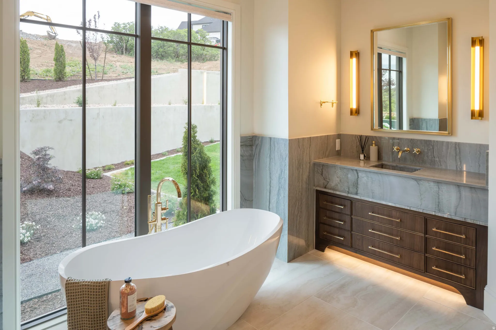 Freestanding soaking tub with floor-mounted faucet and large picture window