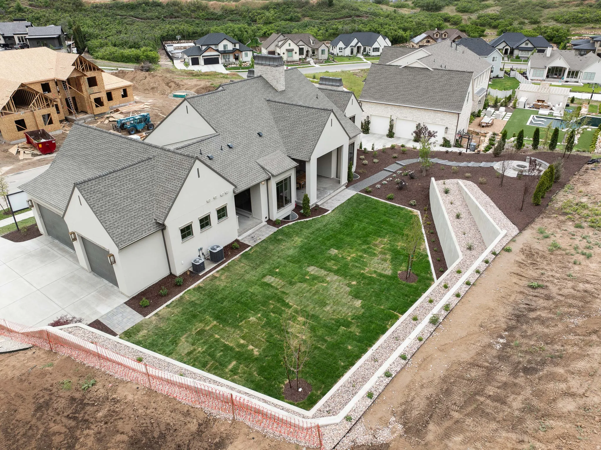 Contemporary stucco exterior with a multi-gabled roof and an attached two-car garage