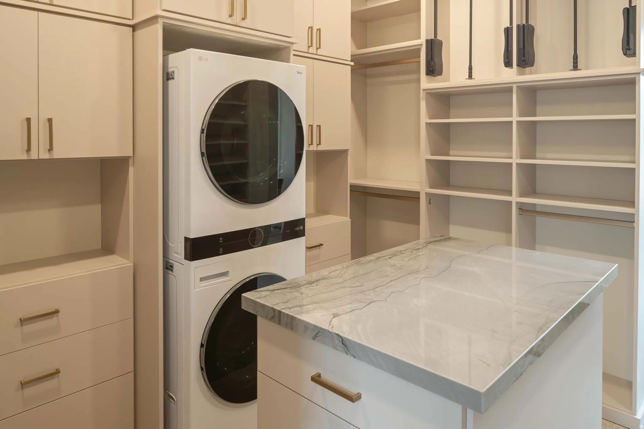 Built-in cabinetry and shelving with integrated washer/dryer unit