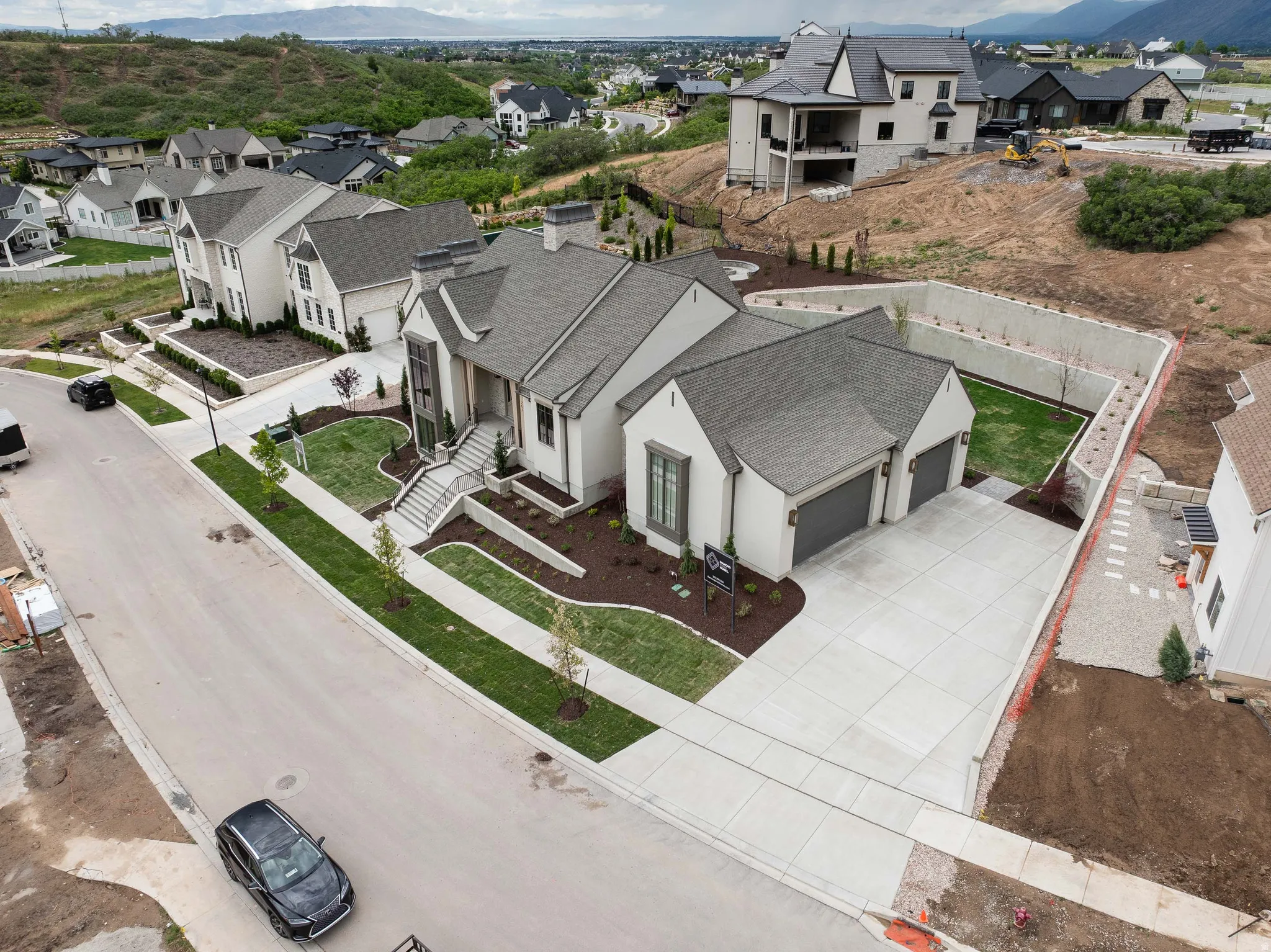 Contemporary residence featuring a light-colored exterior with a dark-pitched roof