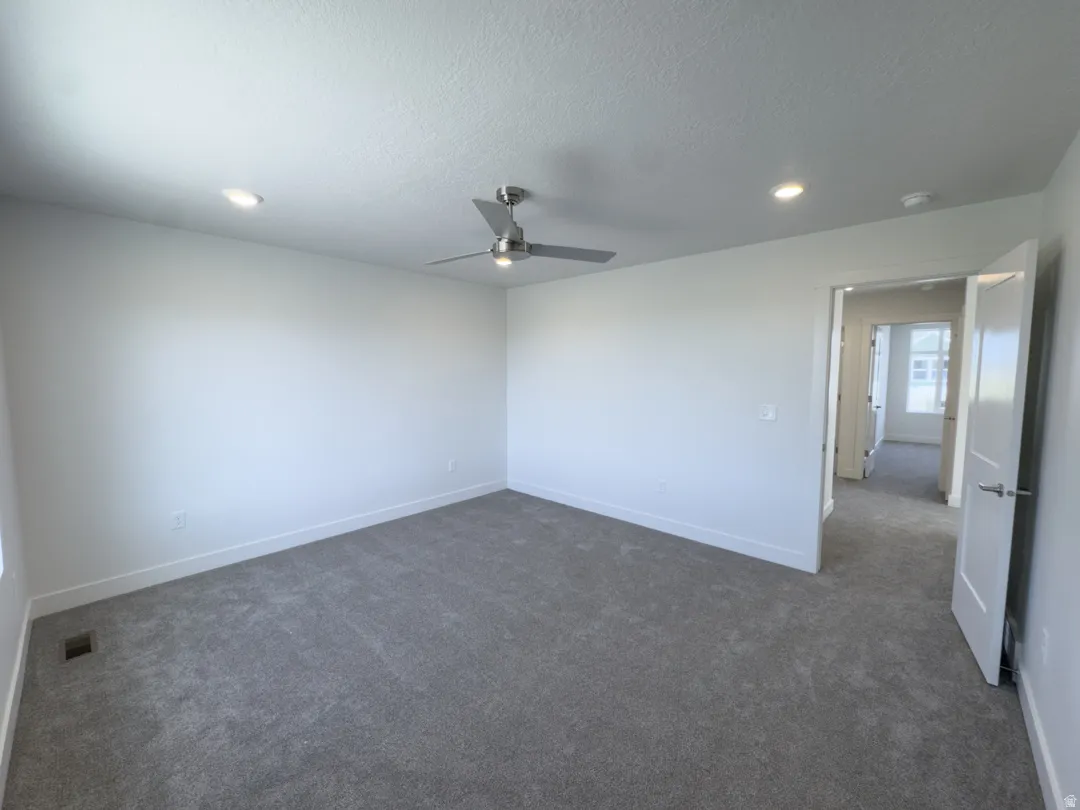 Bright room featuring neutral-toned carpet and white walls
