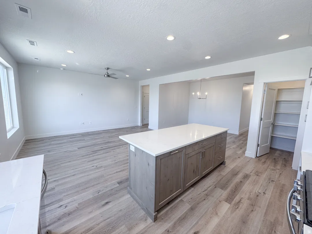 Expansive interior featuring an open layout, wood-finish flooring, and recessed lighting