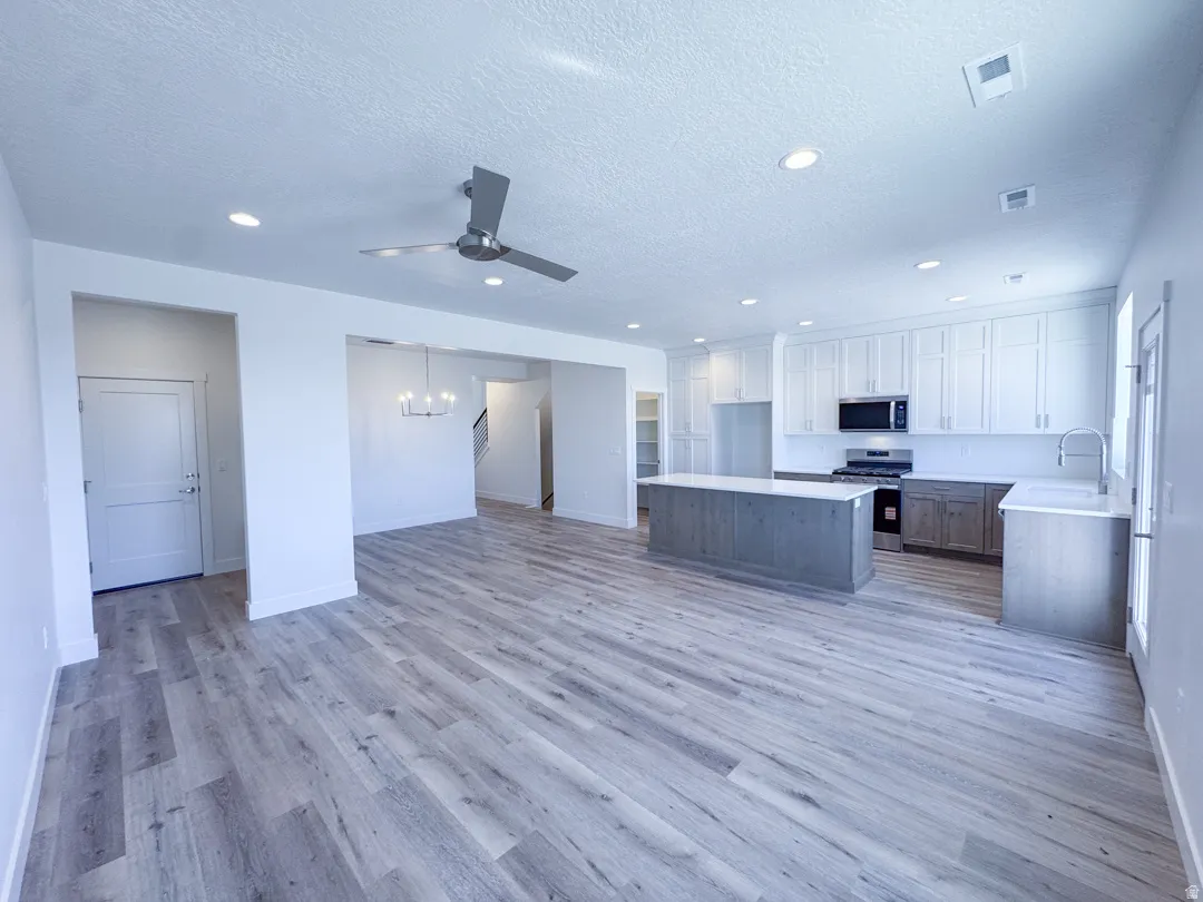 Open-concept living space with wood-finish flooring