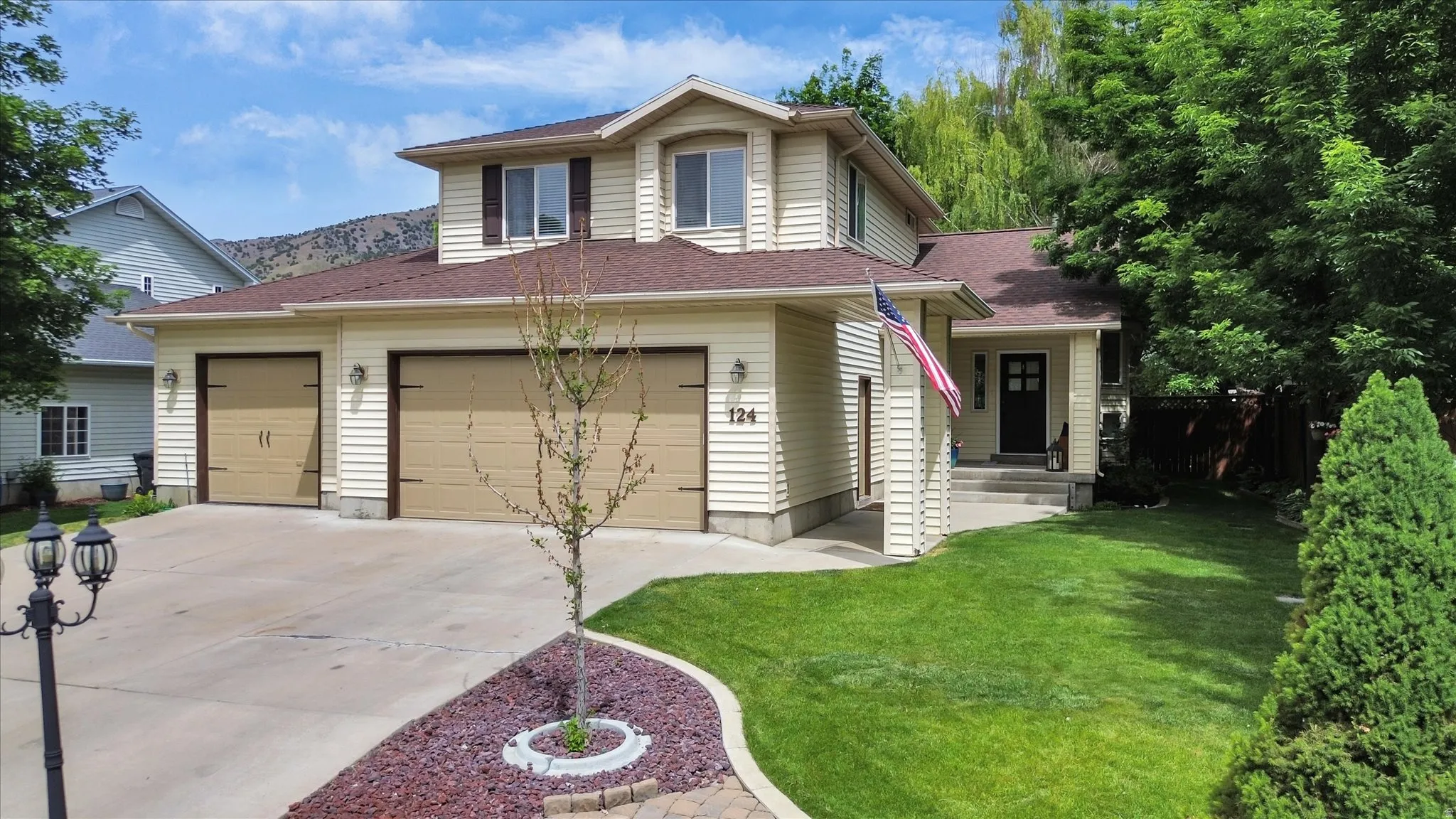 Two-story property featuring horizontal siding and a two-car garage with carriage-style doors