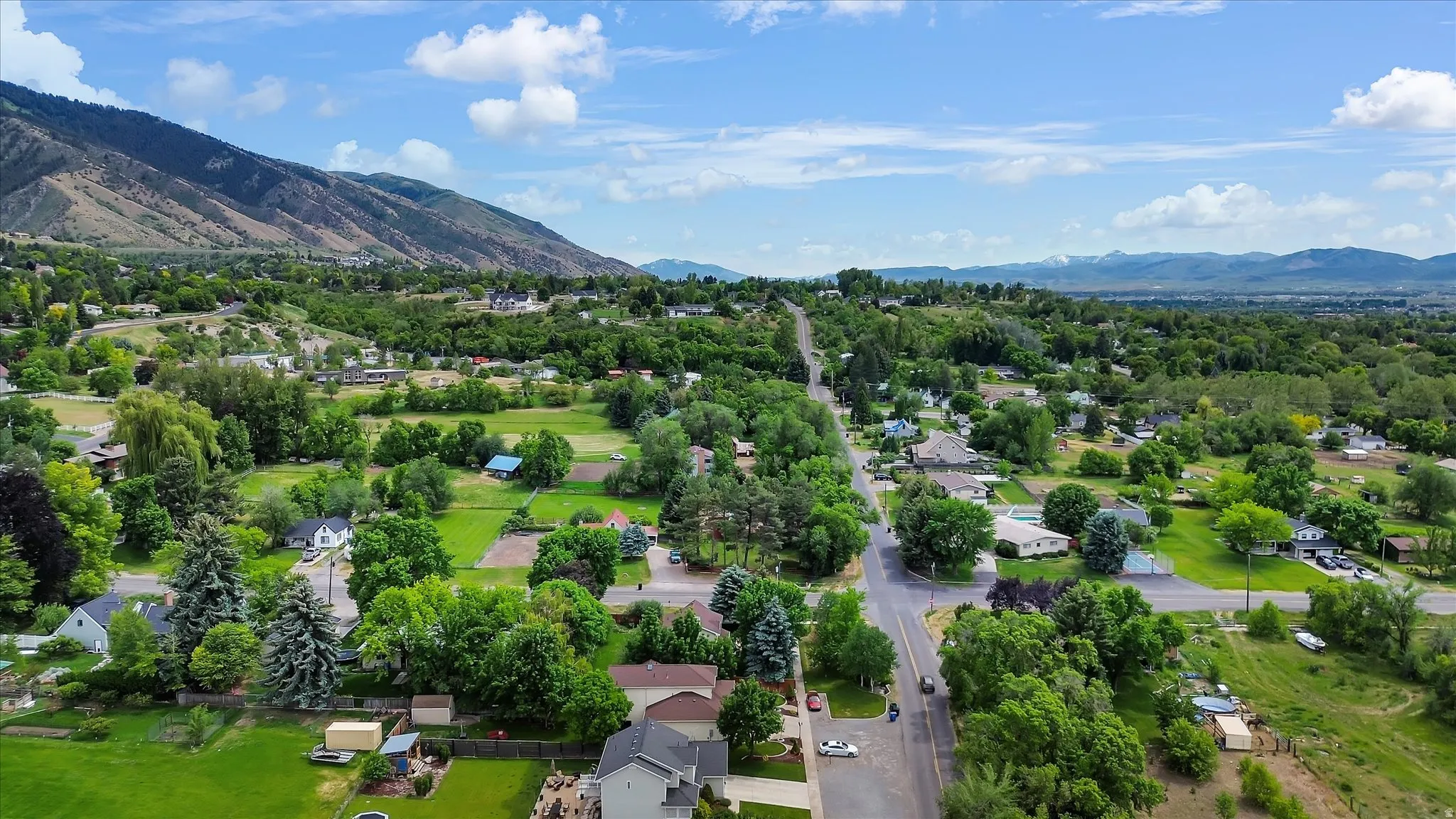 Expansive green landscapes and mature trees define this mountain-backed community
