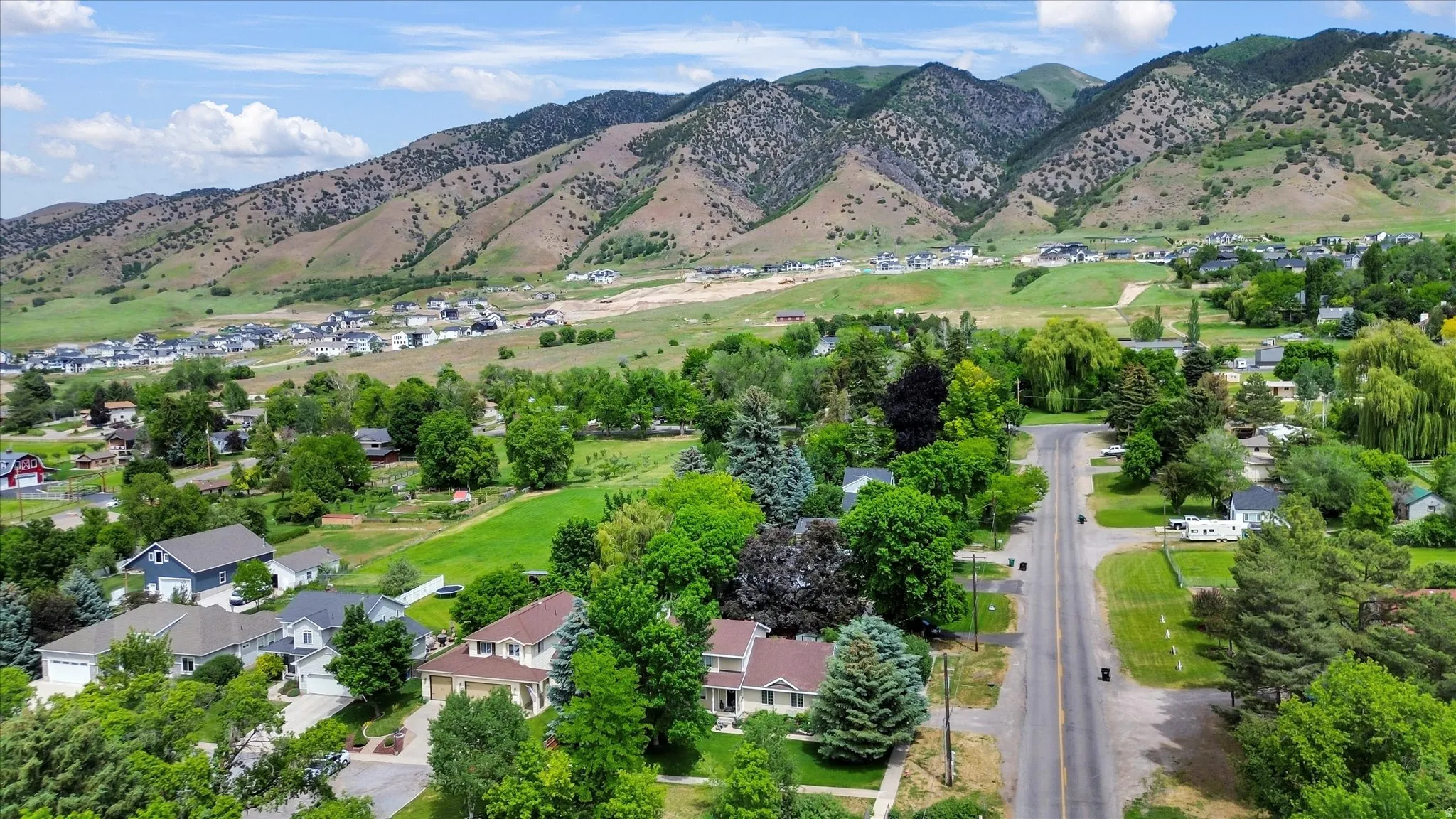 Aerial perspective showcasing a residential community nestled against a mountainous backdrop