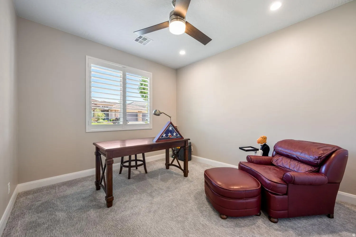 Neutral-toned room with plush carpeting and crisp white baseboards