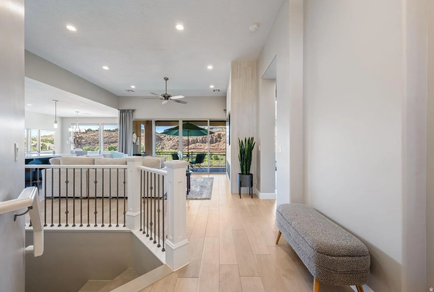 Open concept living area featuring wood-finish flooring, recessed lighting, and a contemporary ceiling fan