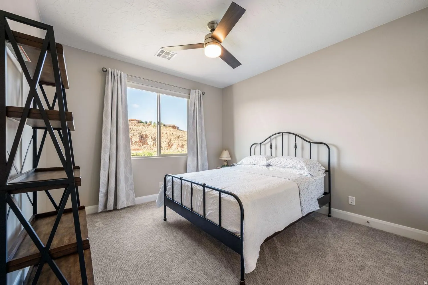 Bedroom with neutral-toned walls and carpet flooring