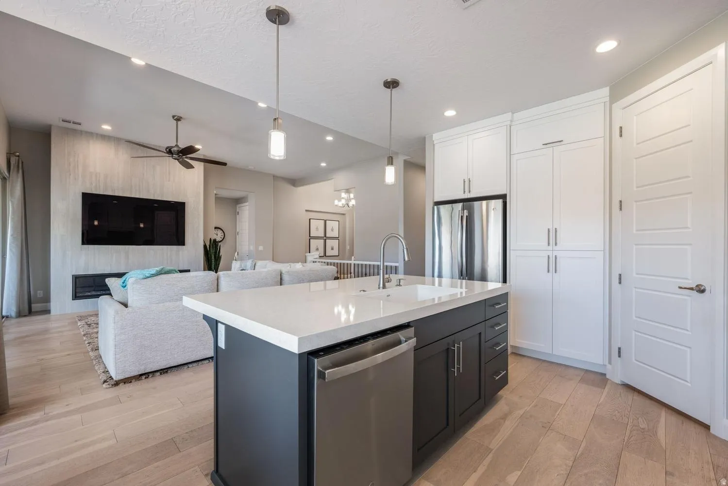 Open-concept living space with light wood-finish flooring