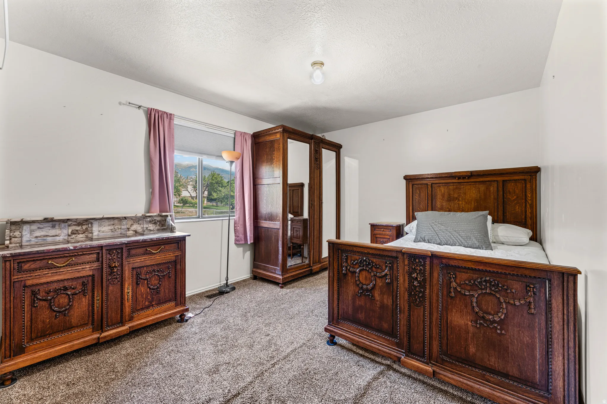 Carpeted room with a window offering exterior views
