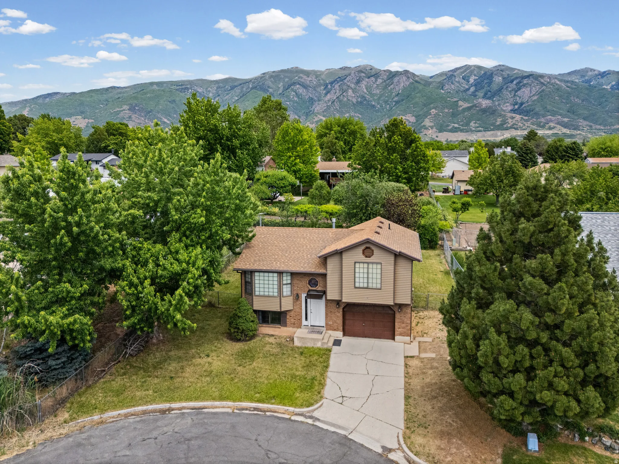 Mountain backdrop framing a split-level residence with a gabled roof