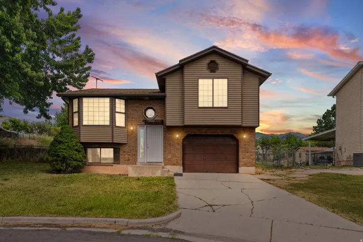 Split-level residence featuring brick and siding exterior