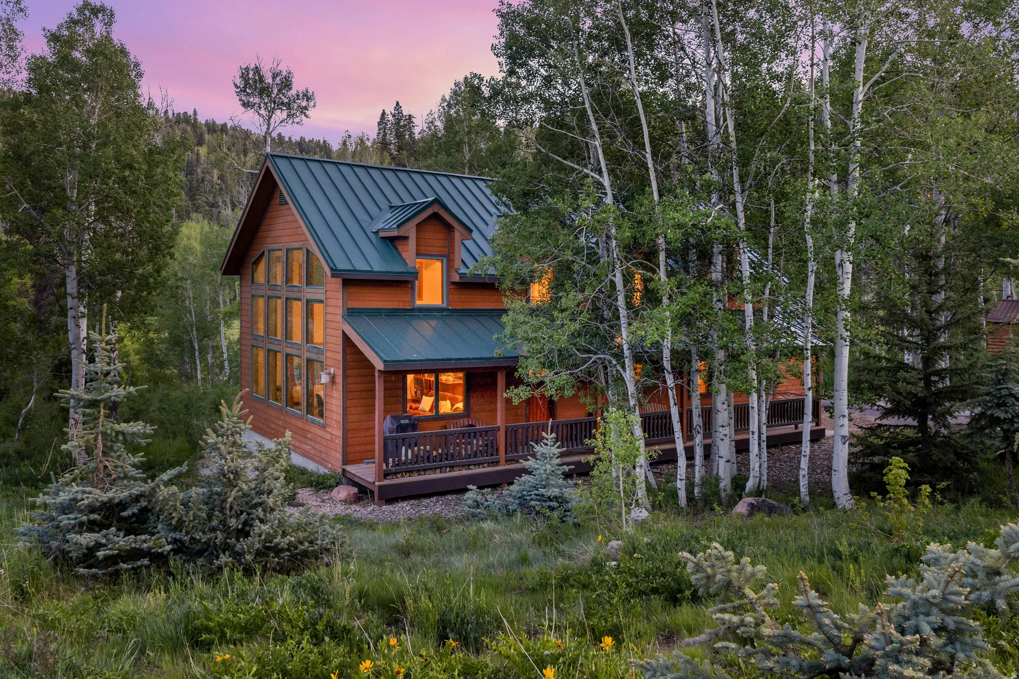 Wood-sided structure with a dark green metal roof