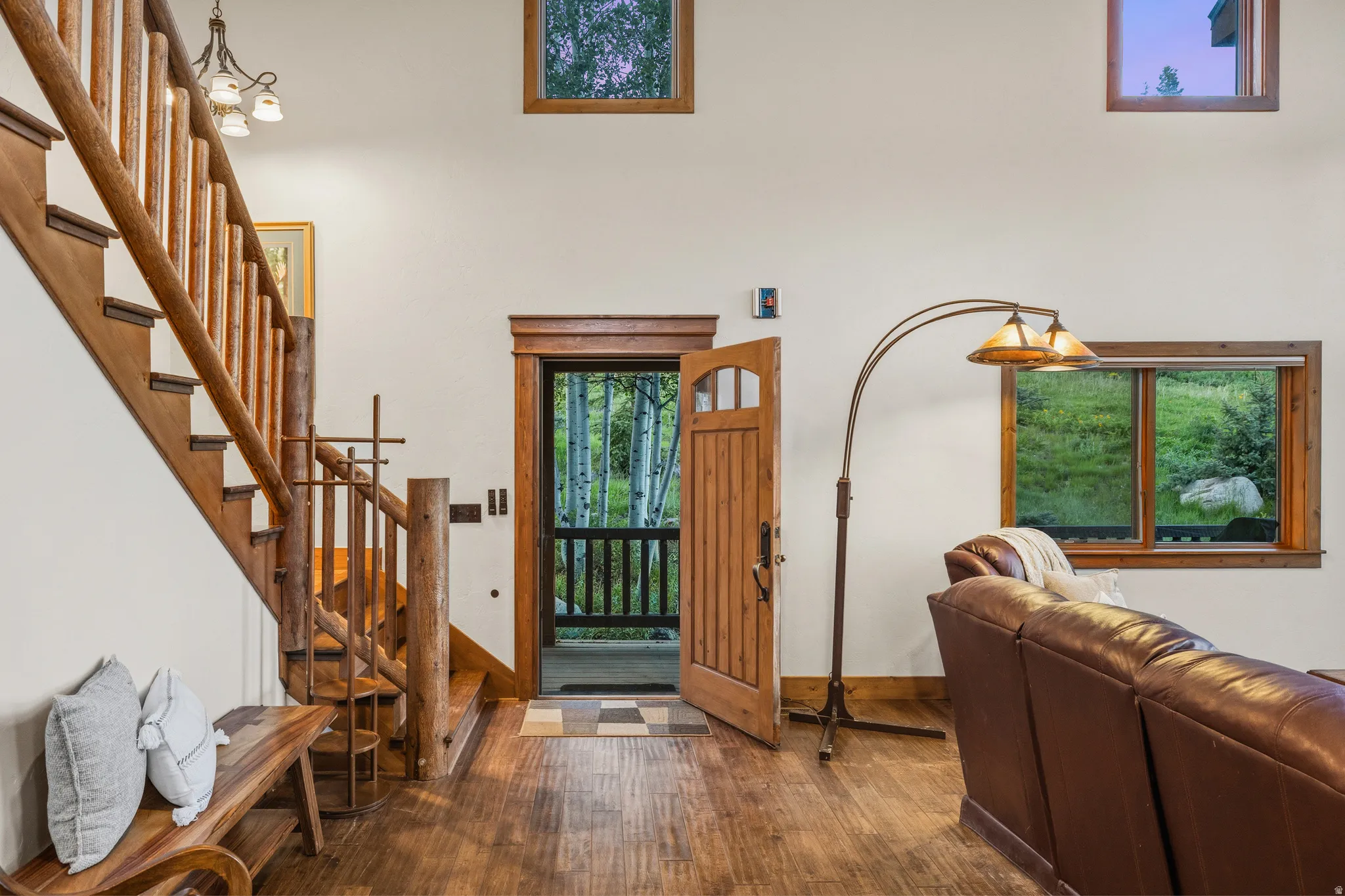 Wood-finish flooring throughout, complemented by a rustic wood staircase and balusters