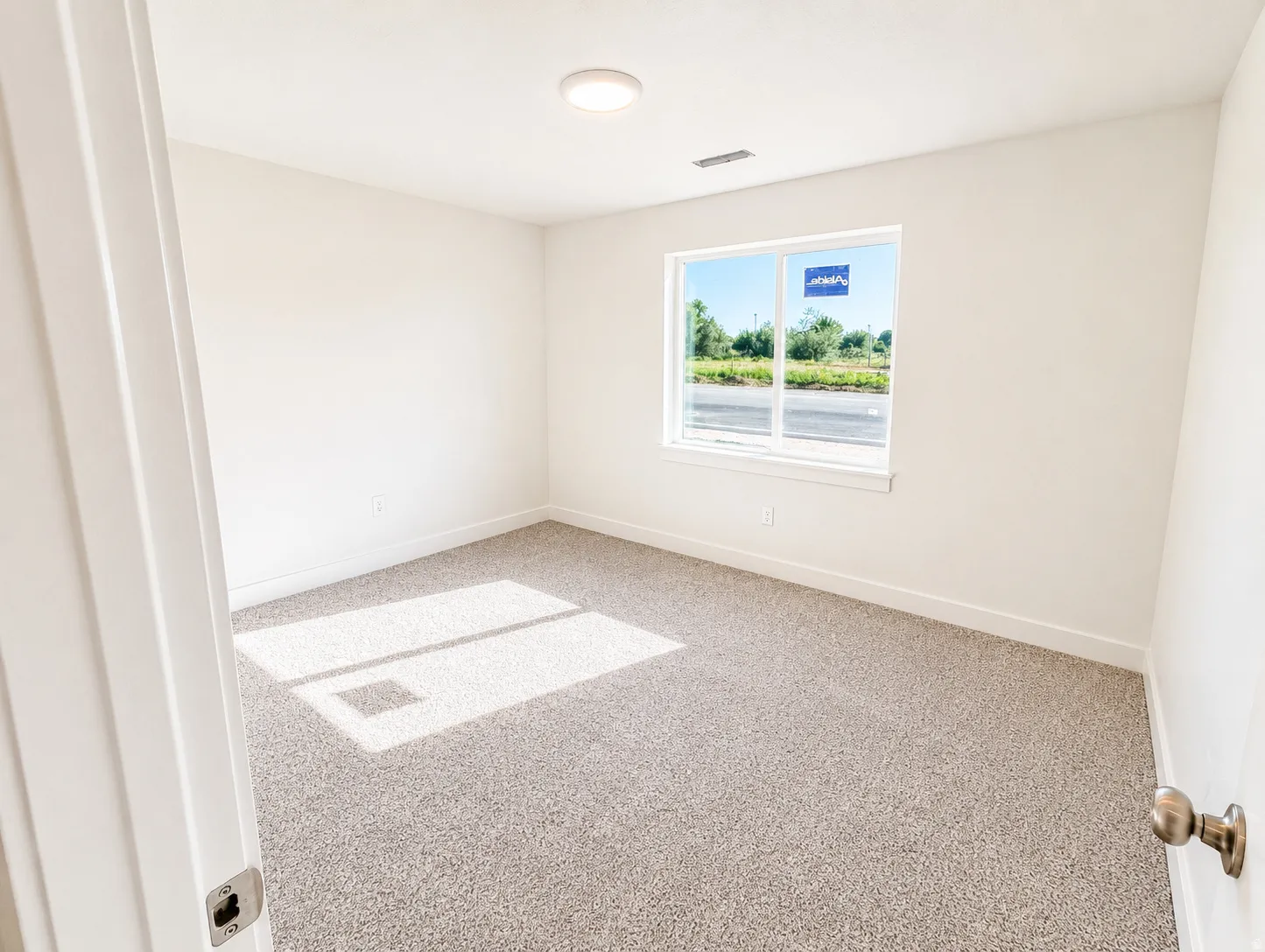 Neutral-toned carpeting complements bright white walls and trim