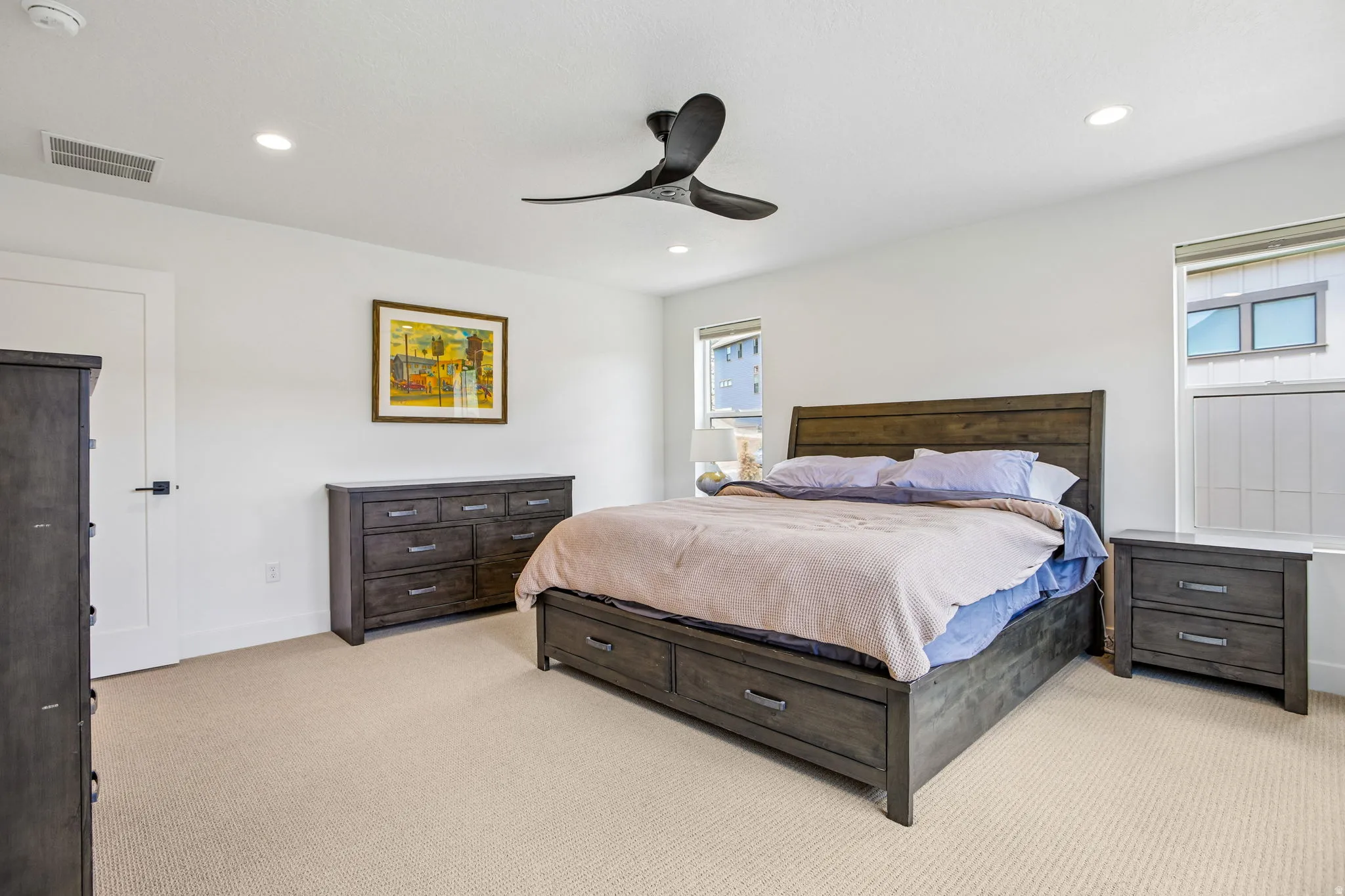 Carpeted bedroom featuring white walls, recessed lighting, and a contemporary ceiling fan