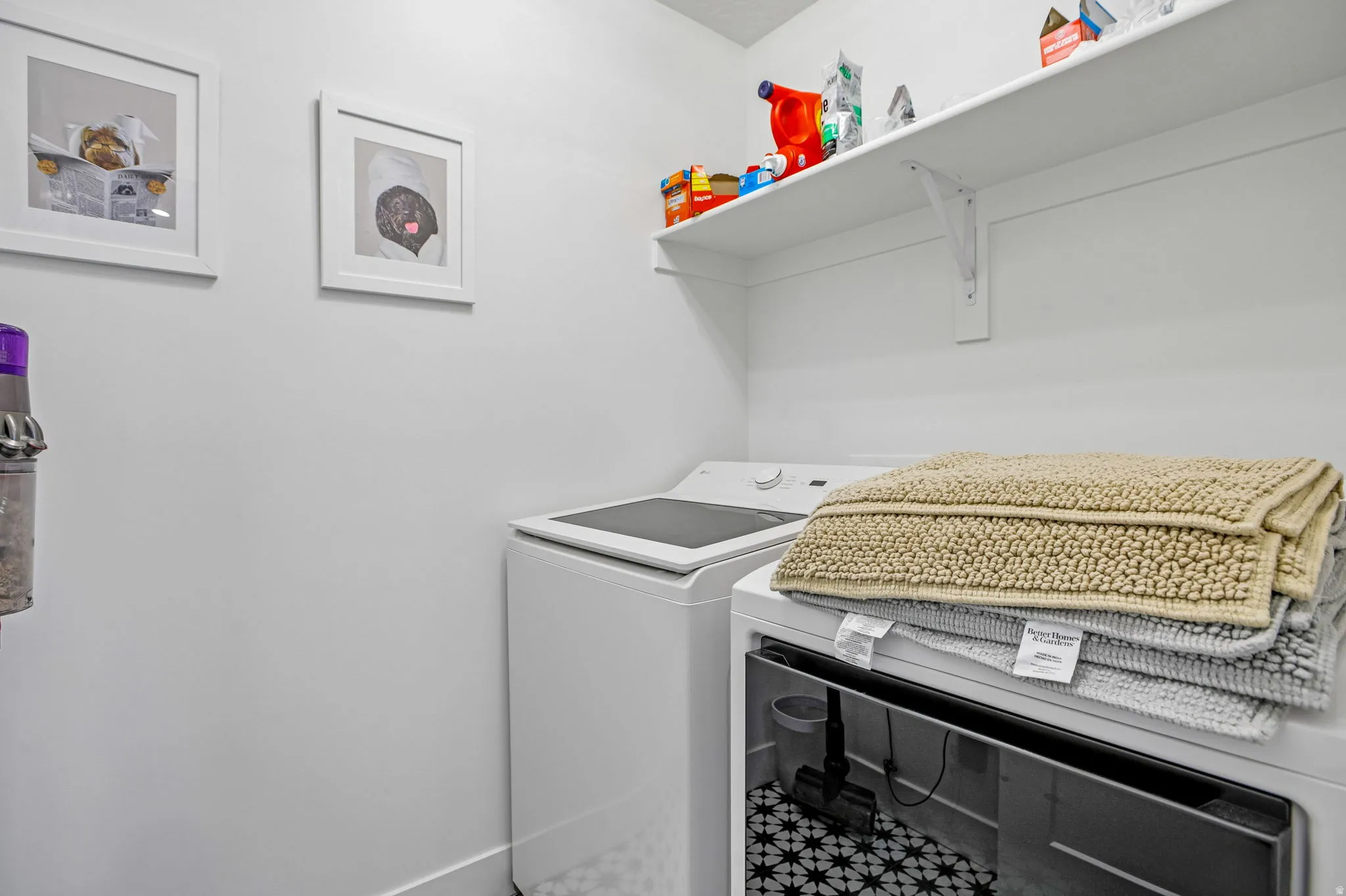 Dedicated laundry space featuring a white top-load washer and front-load dryer