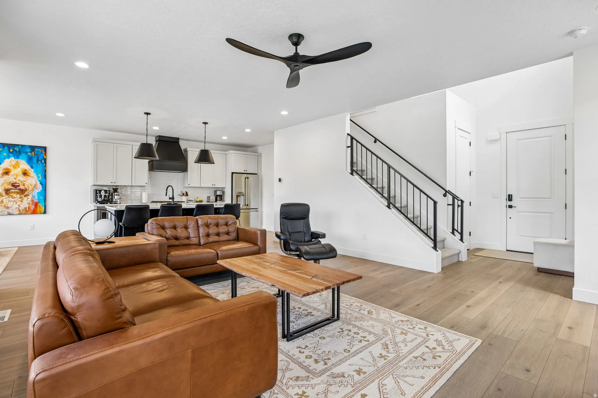 Open-concept living area featuring light wood-finish flooring