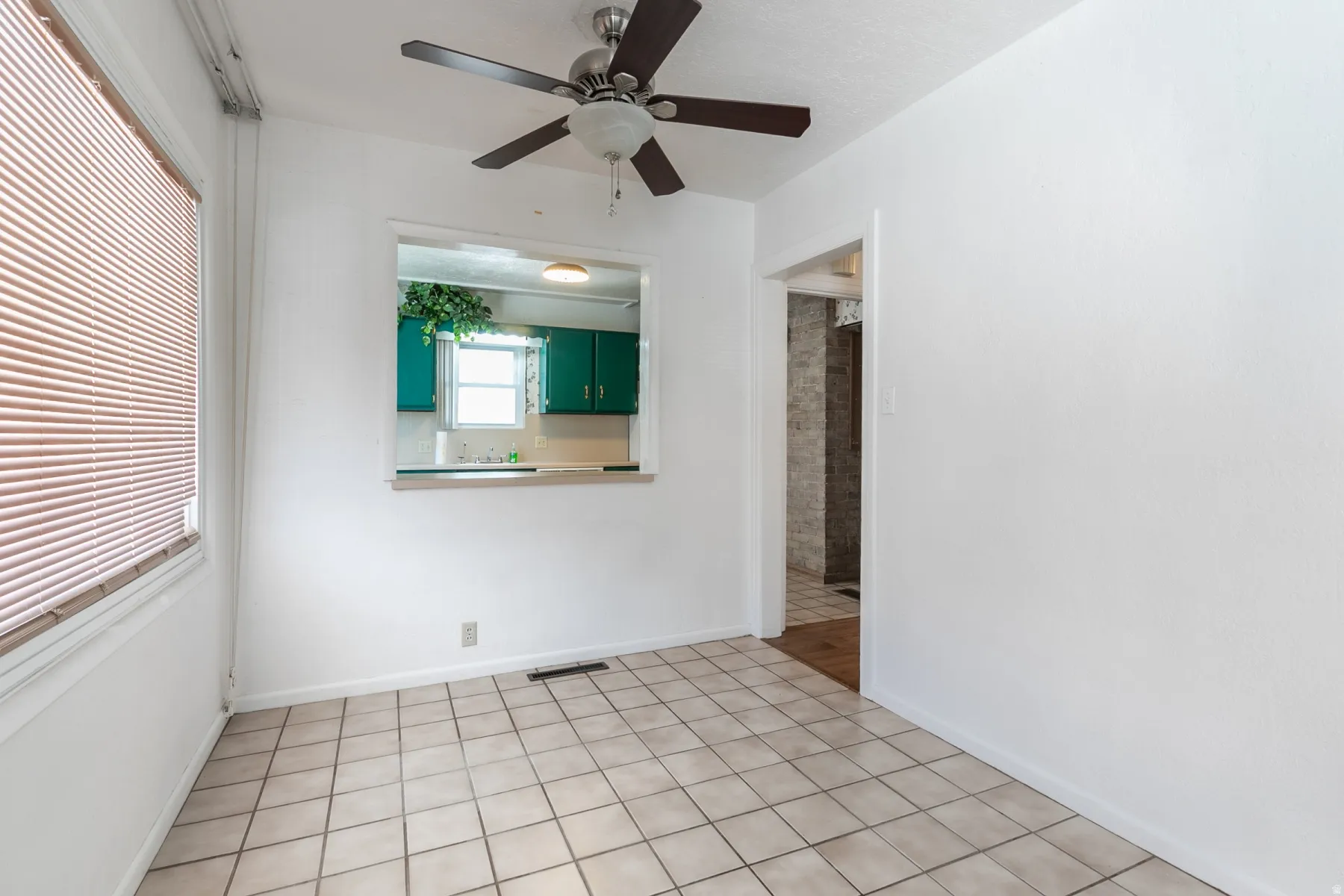 Neutral-toned square tile flooring throughout this bright room
