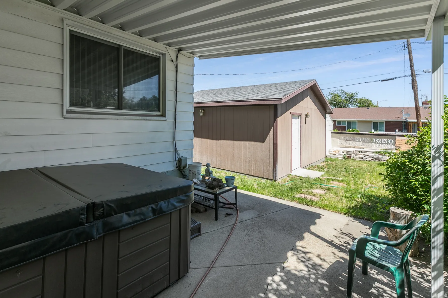 Covered patio with concrete slab flooring and exterior siding