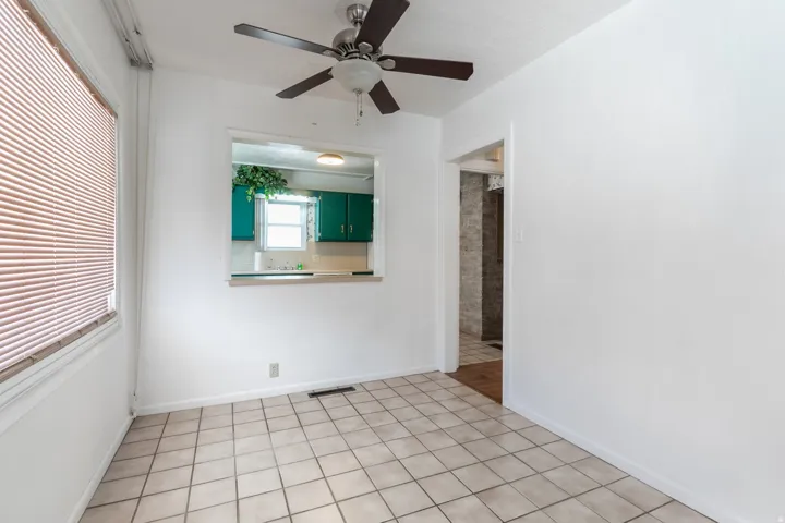 Neutral-toned square tile flooring throughout this bright room