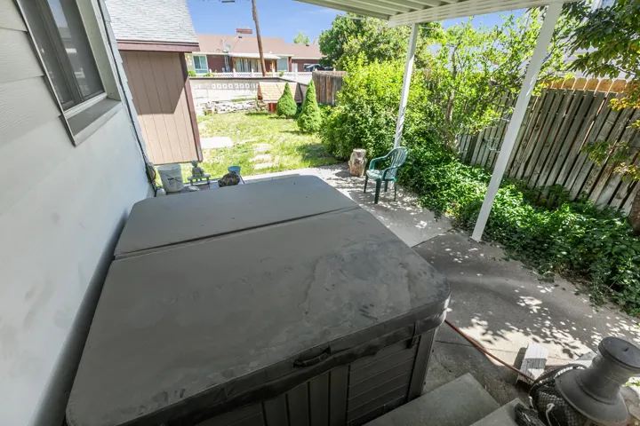 Exterior patio space featuring a hot tub, concrete paving, and a covered pergola