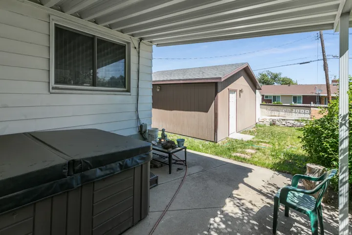 Covered patio with concrete slab flooring and exterior siding