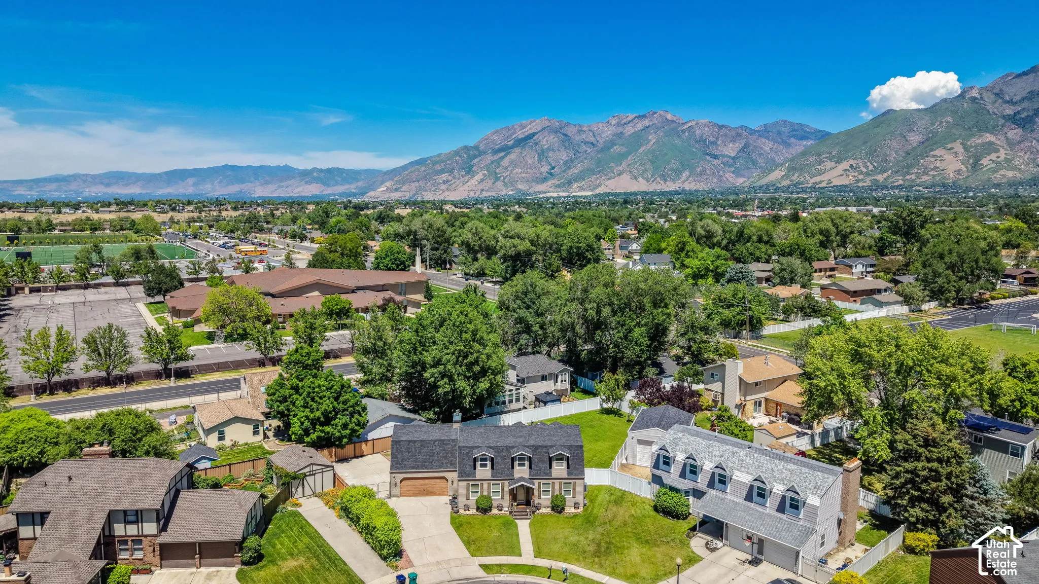 Aerial perspective showcasing a residential area with a prominent mountain backdrop