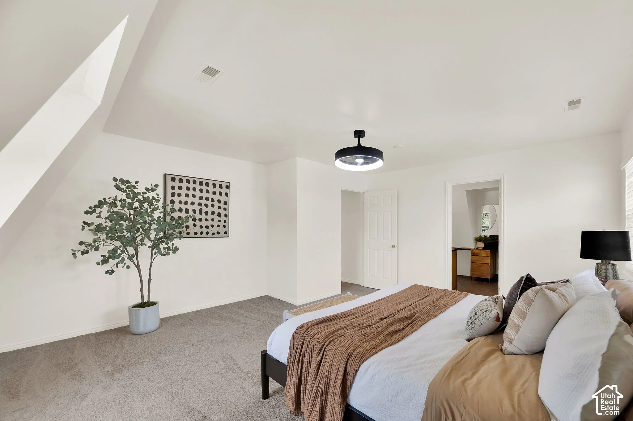 Carpeted room featuring a sloped ceiling detail, recessed lighting, and a modern ceiling light fixture