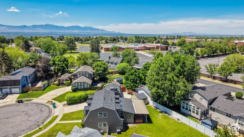 Aerial perspective showcasing a residential neighborhood with distant mountain ranges