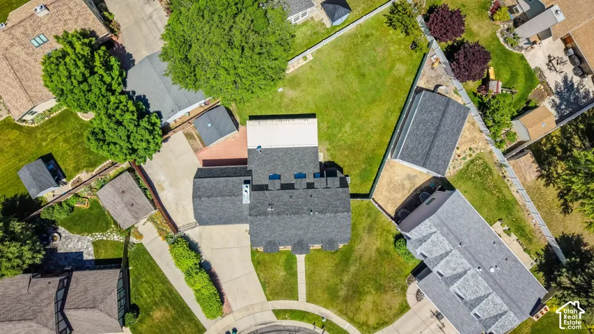 Overhead perspective showcasing a substantial residential property with an expansive, manicured lawn