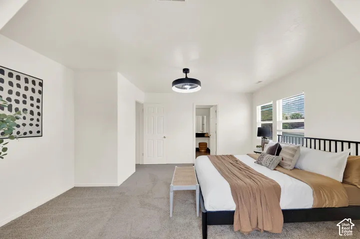 Spacious room featuring neutral carpet flooring, recessed lighting, and bright white walls