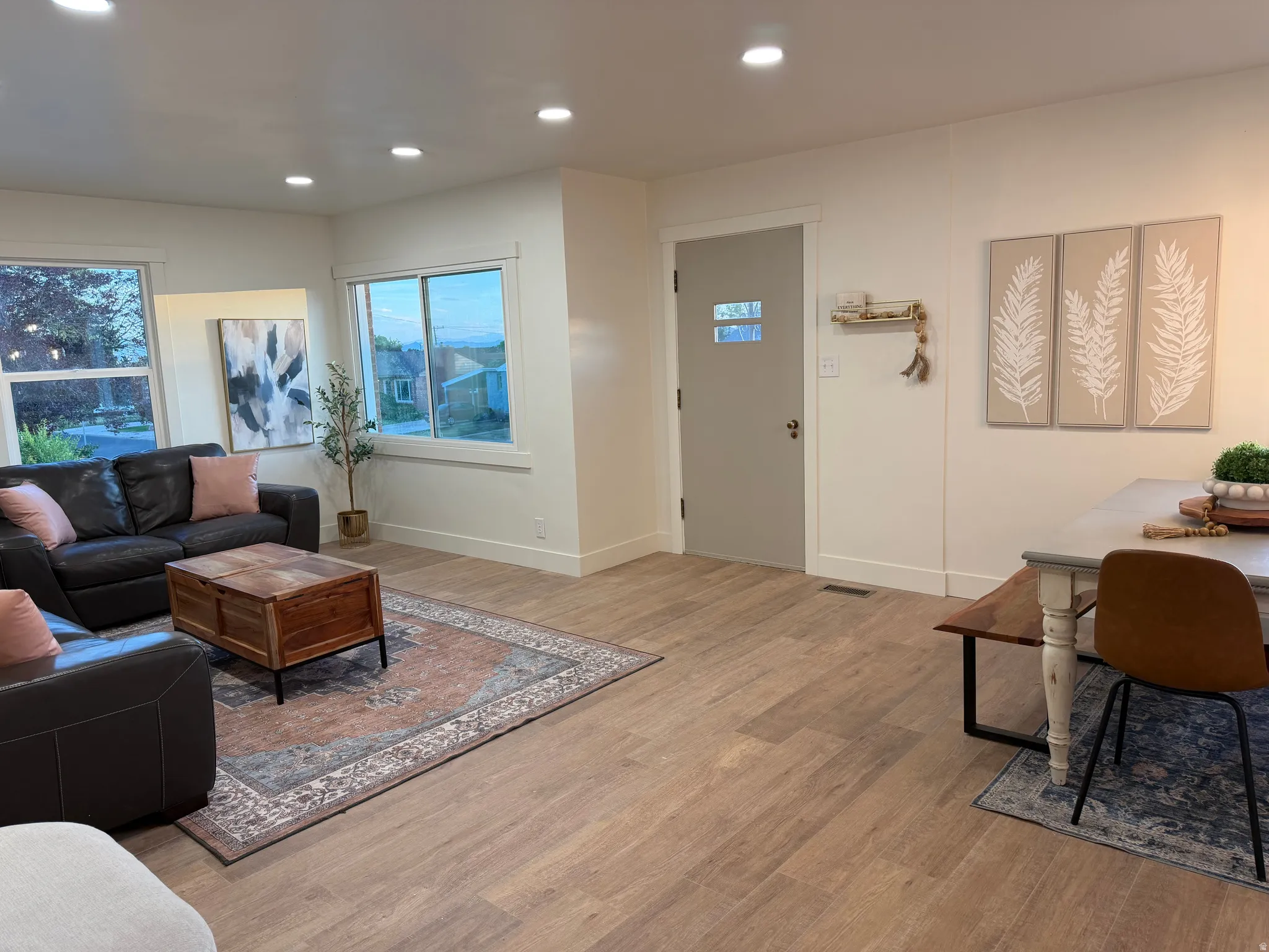 Open-concept living space featuring wood-finish flooring throughout