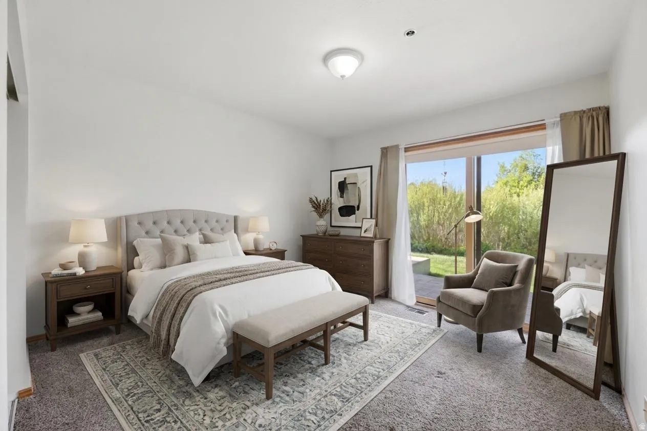 VIRTUAL  RENDERING:Light-filled bedroom featuring a large sliding glass door, white walls, and soft gray carpet