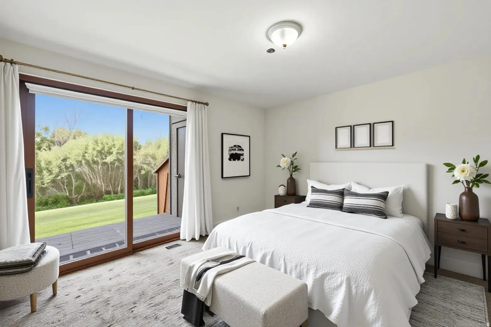 VIRTUAL  RENDERING:Spacious sleeping area featuring a wide glass sliding door, a private deck, light-toned walls, and a contemporary ceiling fixture