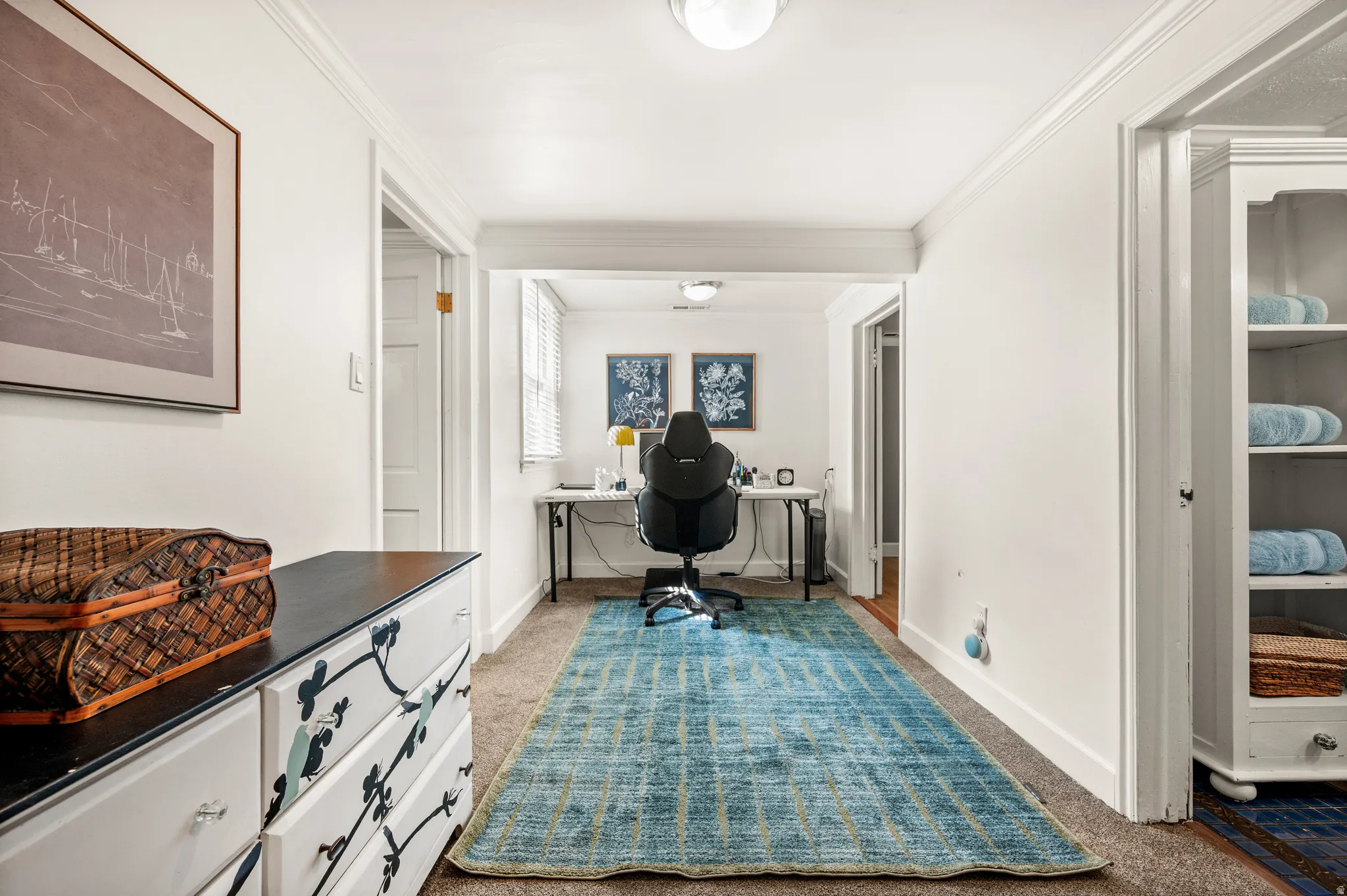 Dedicated office space featuring a window with blinds