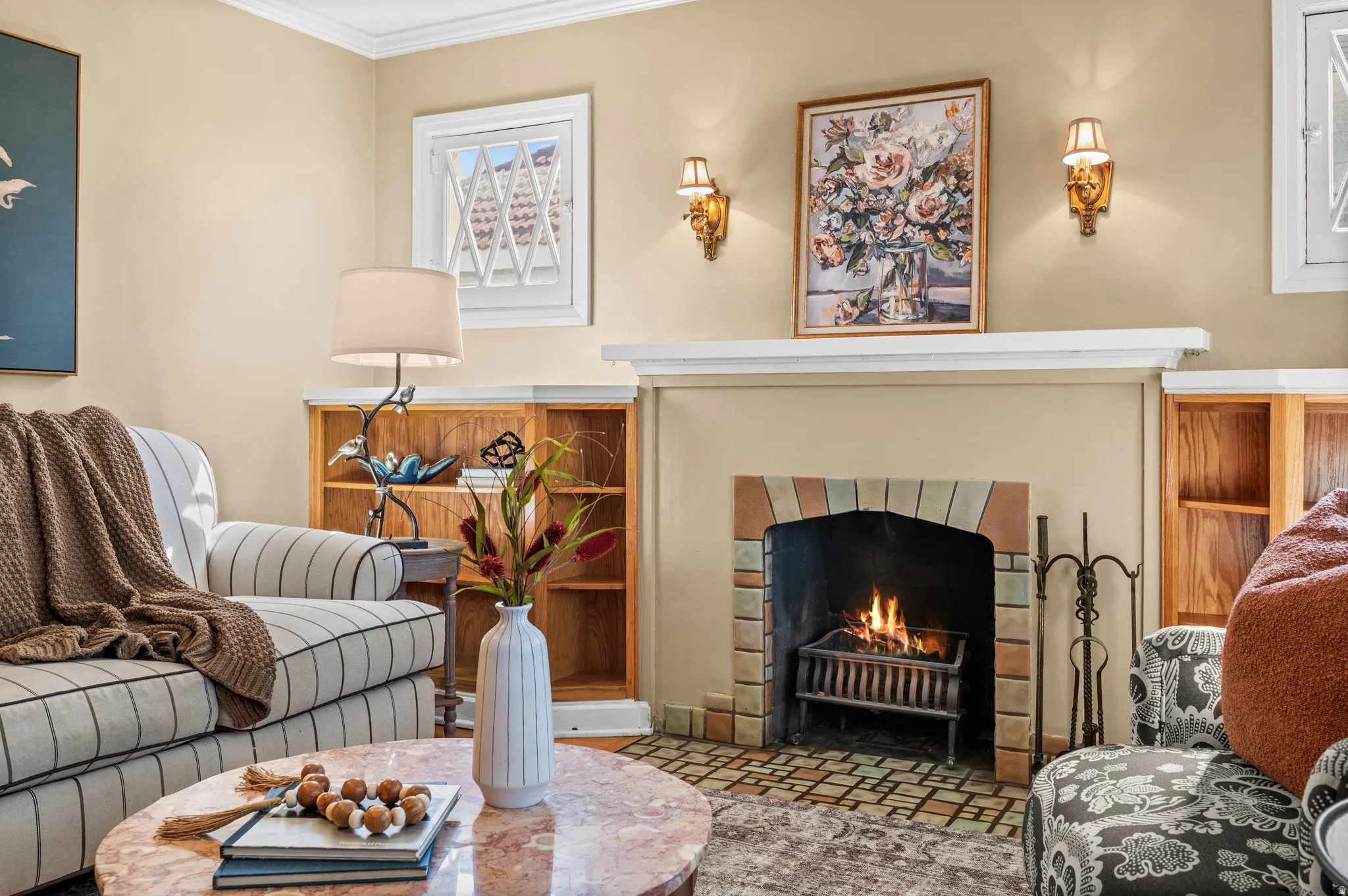 Fireplace featuring a tiled surround and hearth, flanked by built-in shelving units