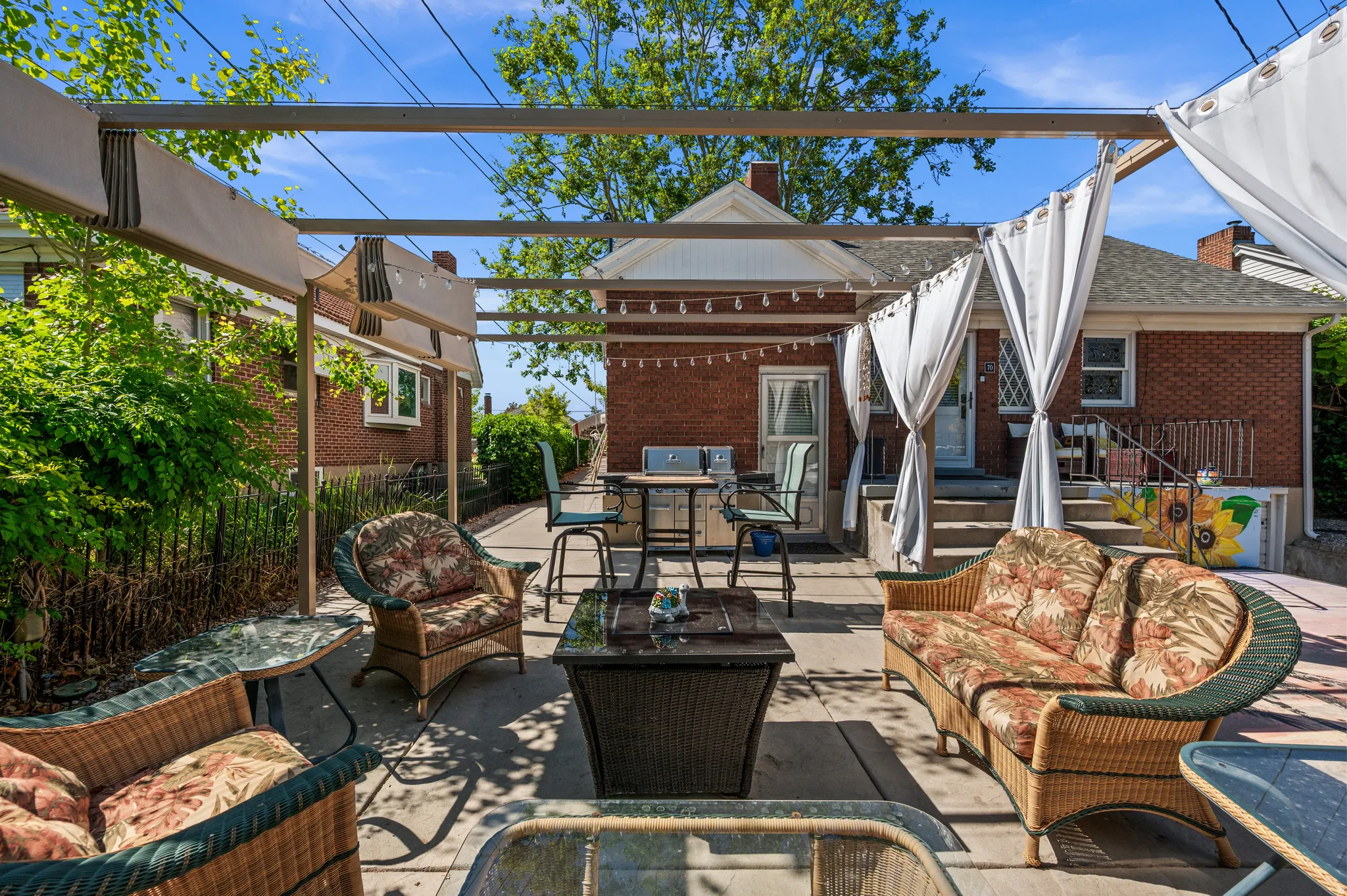 Expansive patio area featuring a pergola structure with retractable canopies