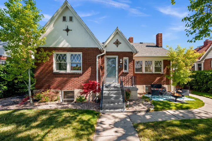 Brick exterior facade with white gable accents and decorative elements