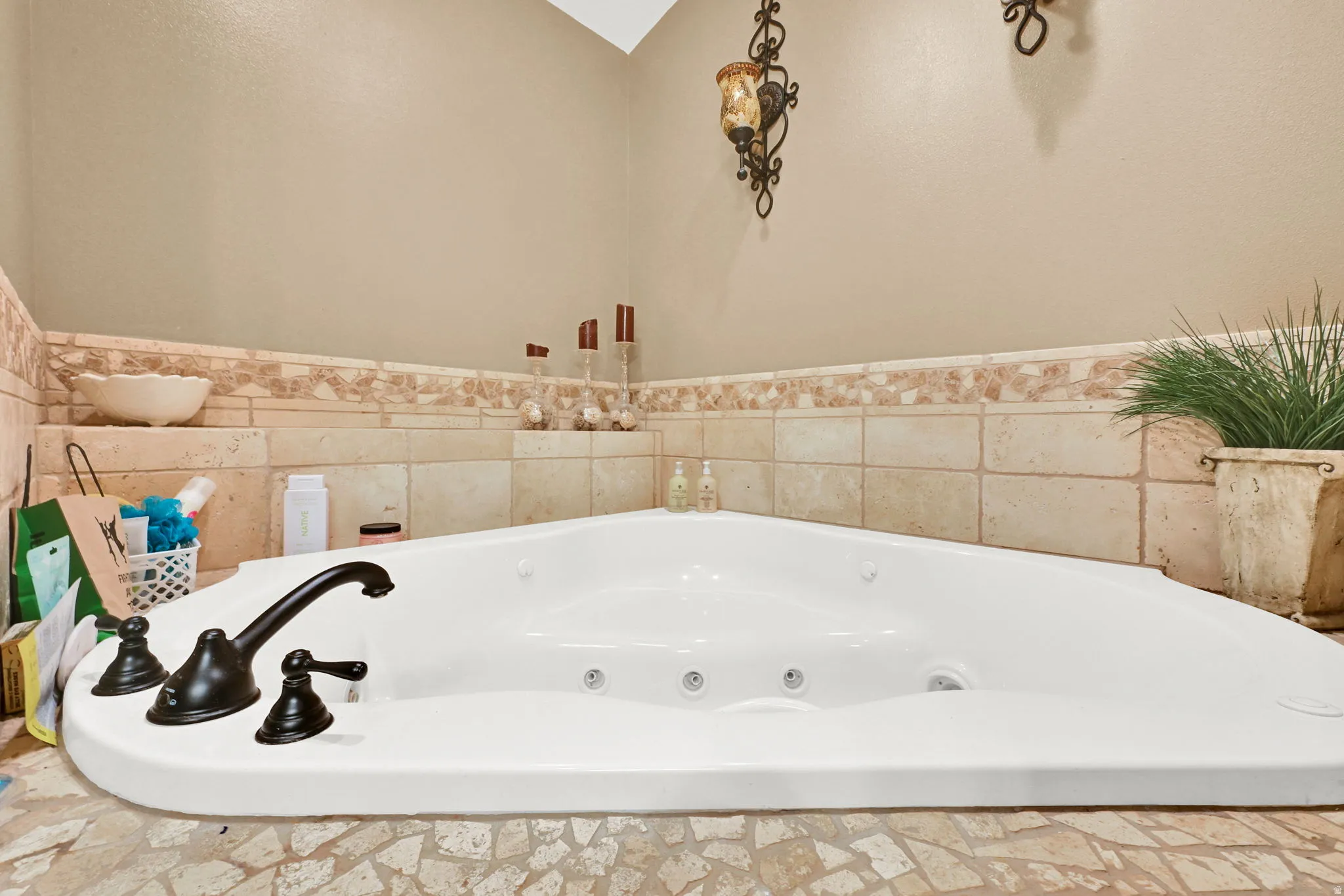 Corner soaking tub with bronze-finish fixtures