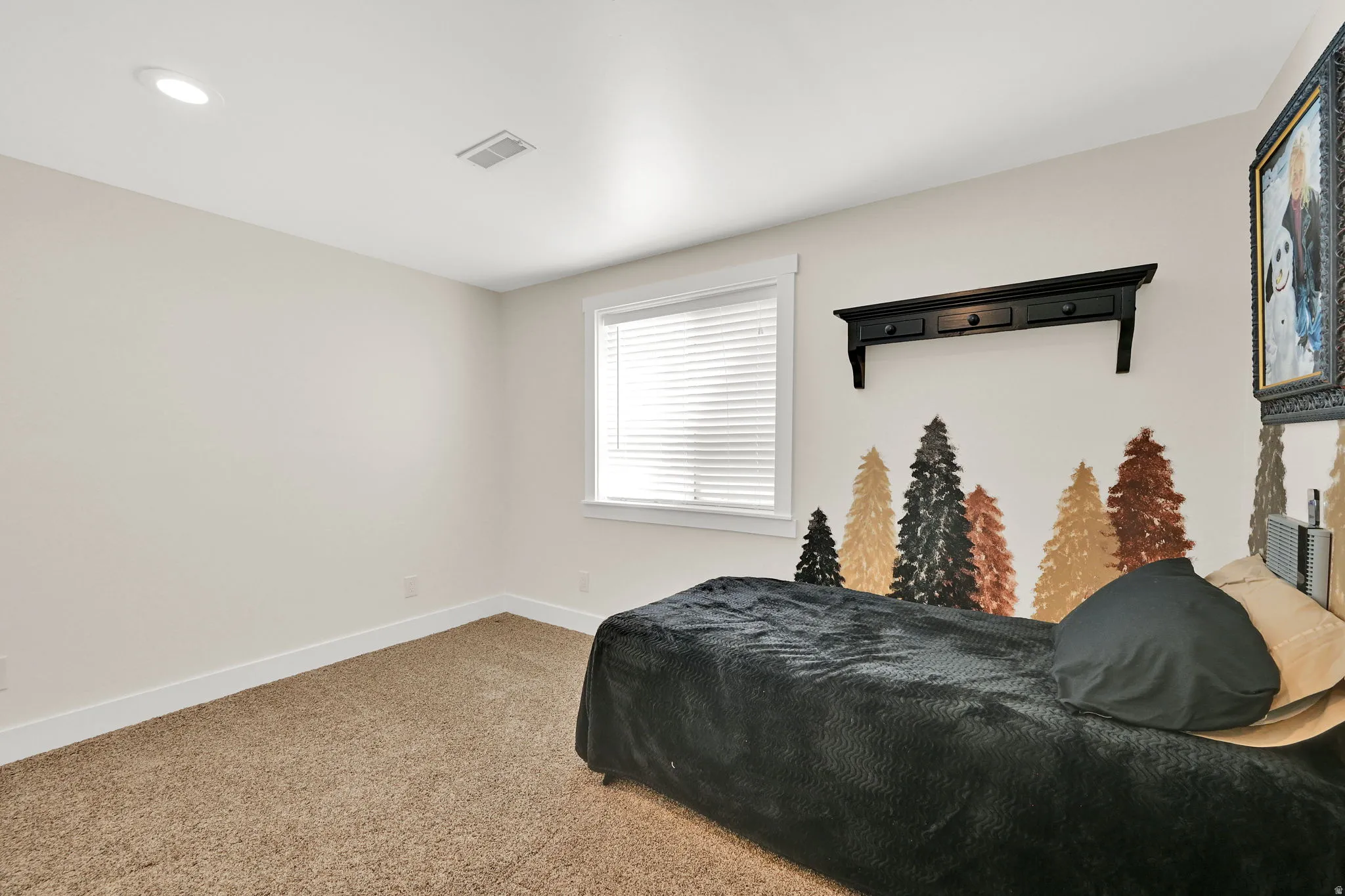 Carpeted room featuring a single window with blinds, recessed ceiling lighting, and a wall-mounted shelf