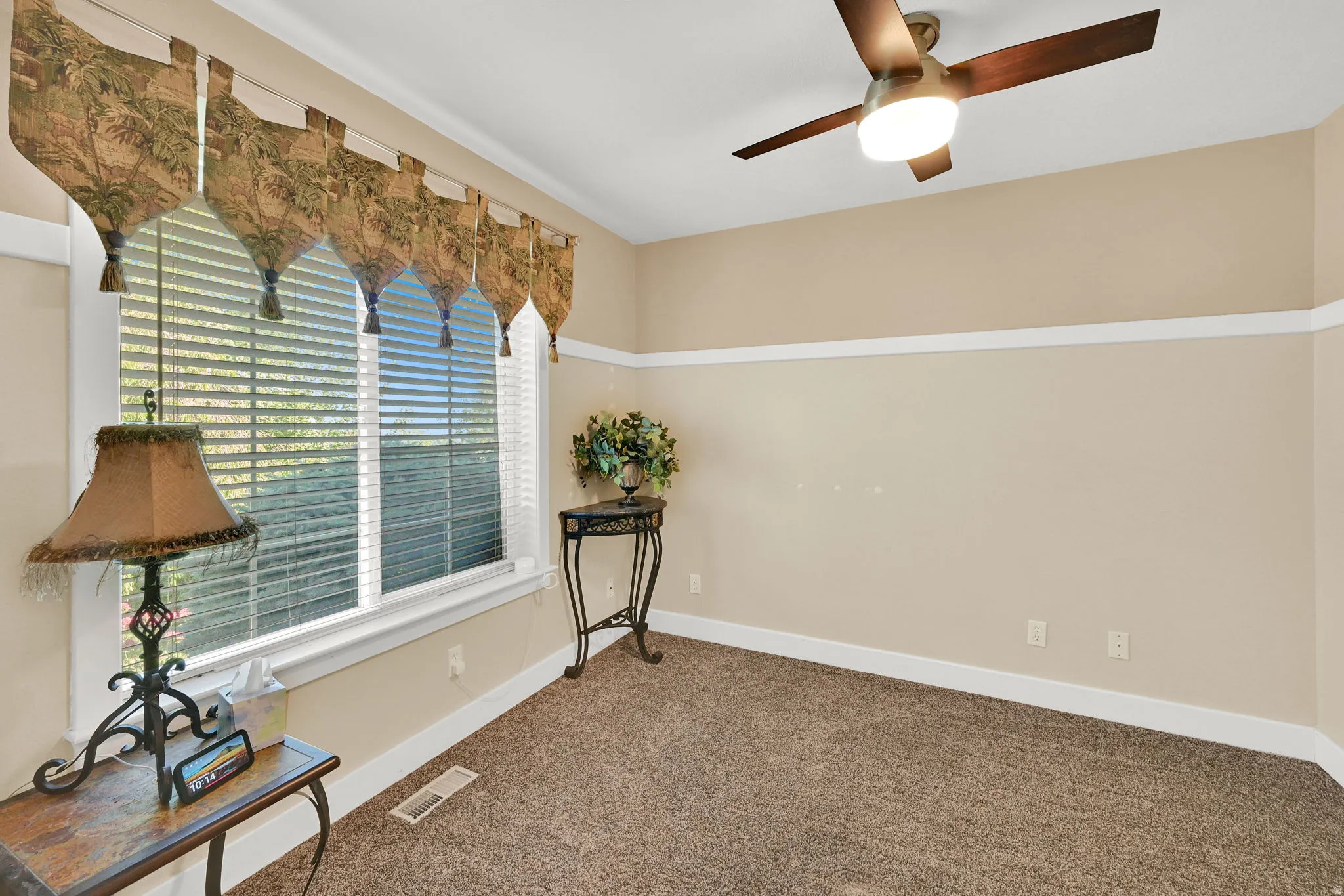 Recessed window with white blinds and decorative valance