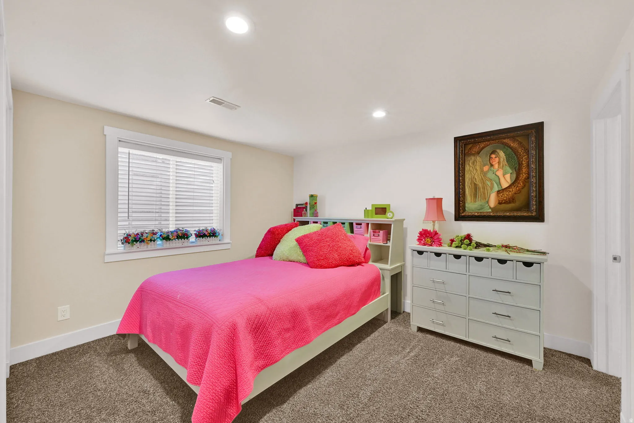 Inviting bedroom featuring neutral wall paint, recessed lighting, and a window with white blinds