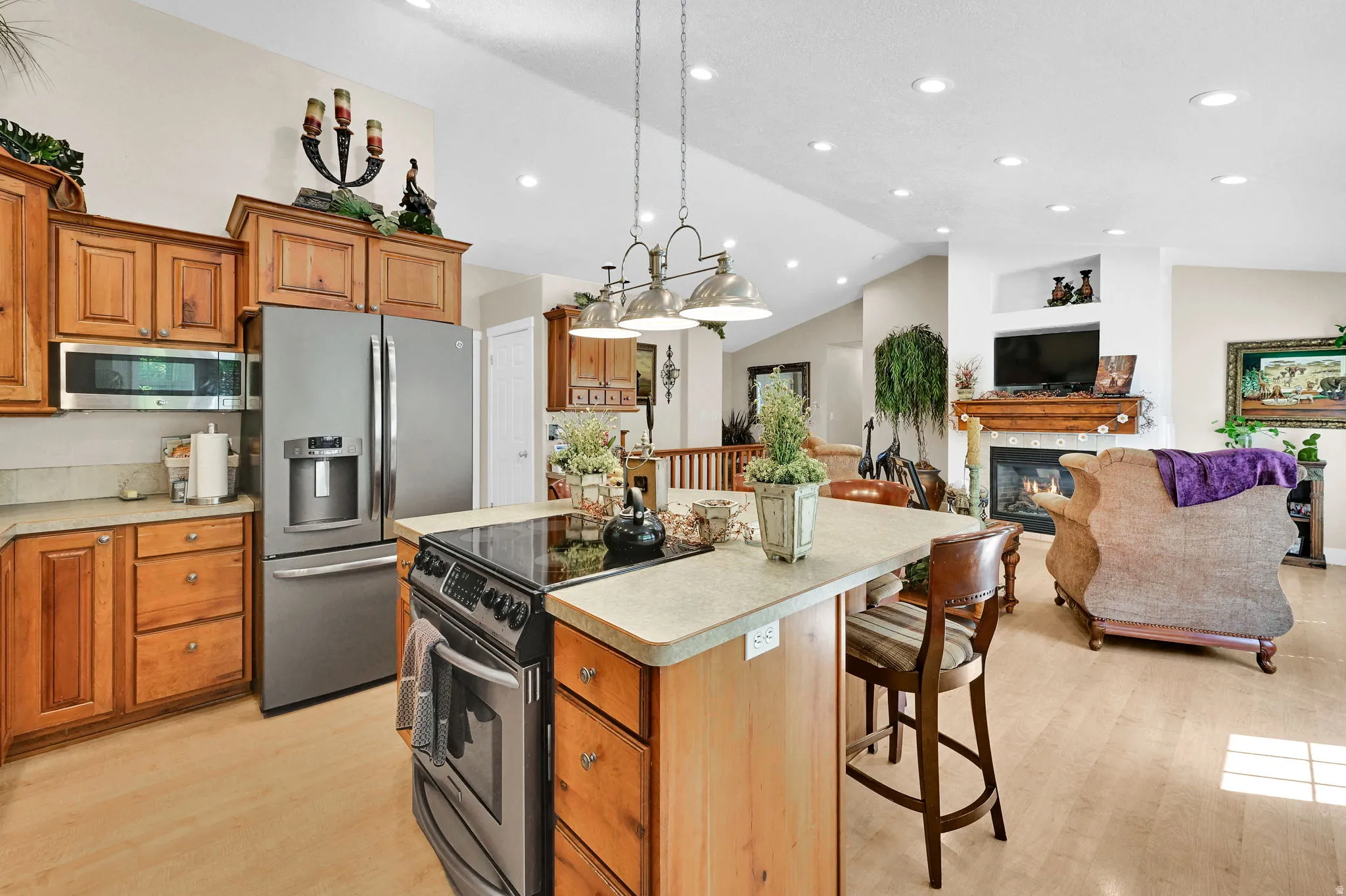 Open concept kitchen and living area featuring wood-finish flooring