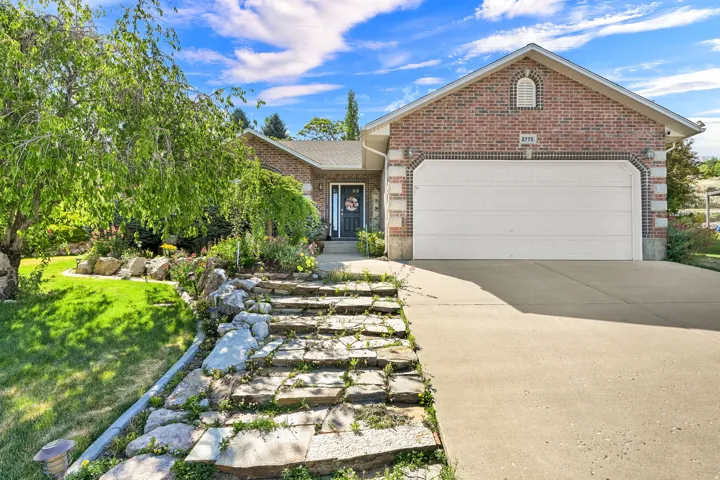 Brick exterior with stone accents and an attached two-car garage