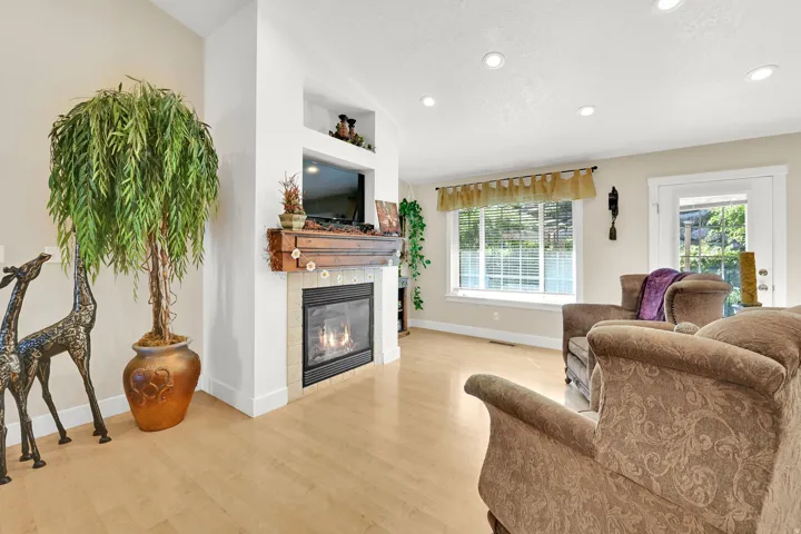 Living area featuring a gas fireplace with a tiled surround and wood mantel
