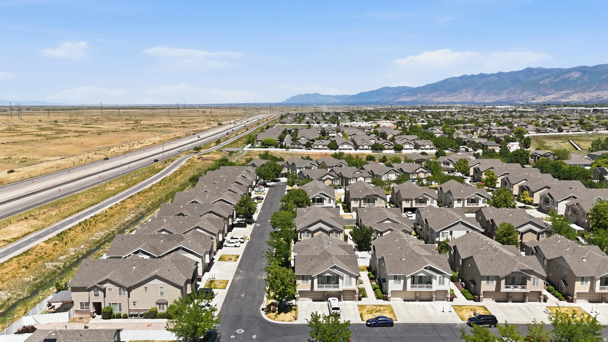 Expansive neighborhood setting featuring numerous single-family homes with gray roofs