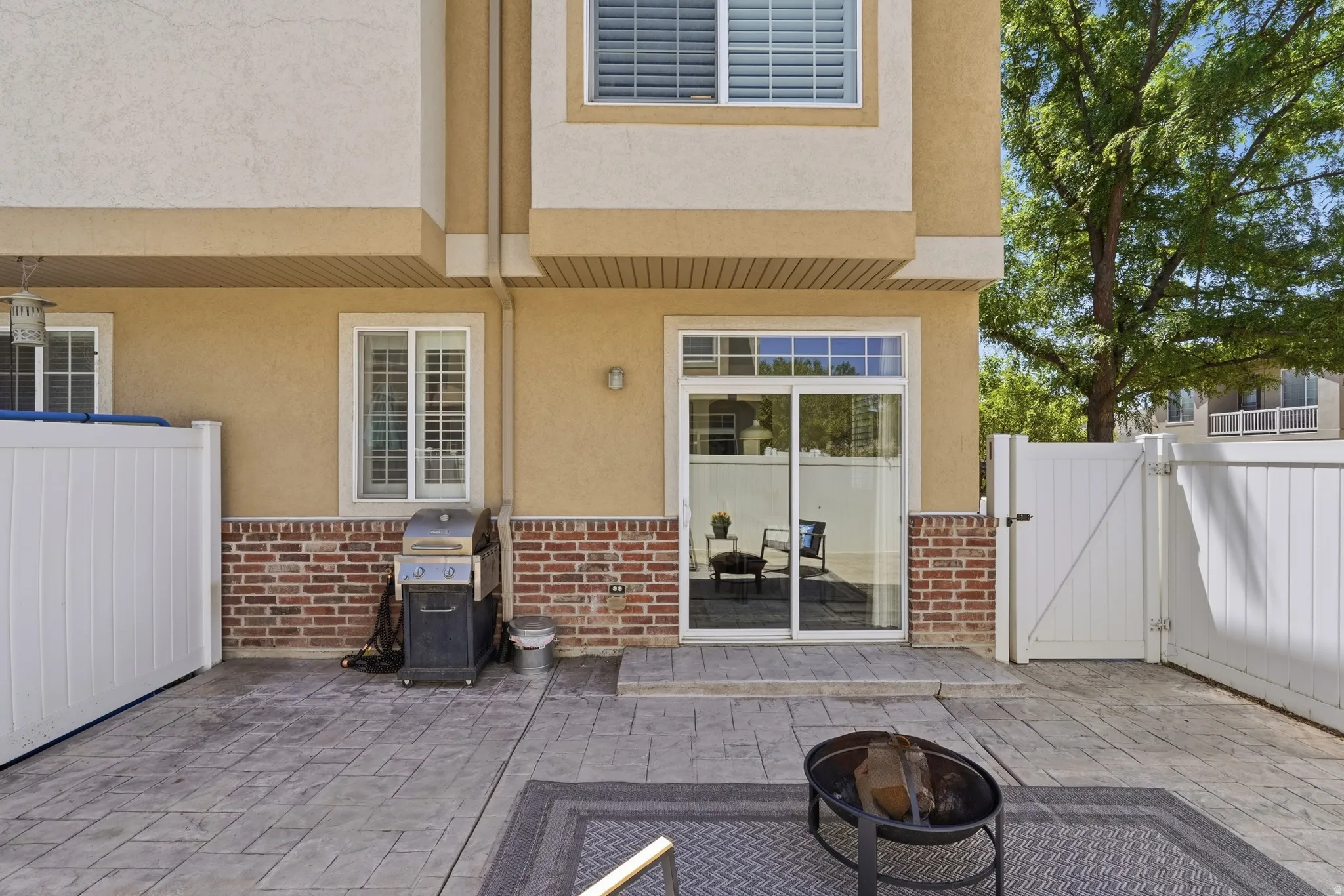 Stamped concrete patio featuring a fire pit
